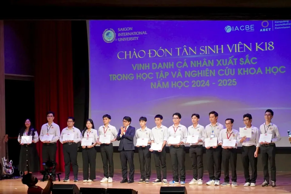 Students holding certificates on stage at SIU's 2024–2025 recognition ceremony.