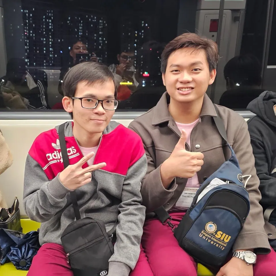 Two people with SIU backpacks on the bus to the competition.