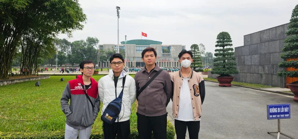 A group photo with friends in a square in Hanoi.